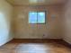 Cozy bedroom featuring hardwood floors and a window overlooking the backyard at 1890 Eaton St, Lakewood, CO 80214