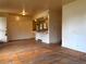 Open floorplan living room with original hardwood floors, and an open kitchen at 1890 Eaton St, Lakewood, CO 80214