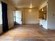 Open floorplan living and dining area featuring original hardwood floors and bright light at 1890 Eaton St, Lakewood, CO 80214