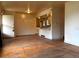 Open-concept living room with hardwood floors, seamlessly flowing into the kitchen and dining area at 1890 Eaton St, Lakewood, CO 80214