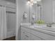 Bright bathroom with double sink vanity, modern fixtures, and tiled shower with glass door at 20272 Terrace View Dr, Parker, CO 80134