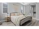 Stylish bedroom boasts a comfy bed, modern decor, and a barn door leading to the ensuite bathroom at 20272 Terrace View Dr, Parker, CO 80134