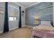 Charming bedroom with a blue wood accent wall, a round rug, and natural light at 20272 Terrace View Dr, Parker, CO 80134