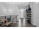 Modern hallway featuring hardwood floors, open staircase, and unique decorative shelving at 20272 Terrace View Dr, Parker, CO 80134