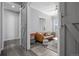 Hallway leading to a stylish living room featuring a sliding barn door and modern decor at 20272 Terrace View Dr, Parker, CO 80134