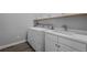 Practical laundry room with modern appliances, sink, and ample cabinet space at 20272 Terrace View Dr, Parker, CO 80134