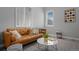 Inviting living room features a leather sofa, patterned rug, and ample natural light from the windows at 20272 Terrace View Dr, Parker, CO 80134