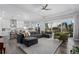 Open-concept living room featuring wood floors, a modern ceiling fan, and sliding glass doors at 20272 Terrace View Dr, Parker, CO 80134