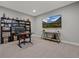 Modern office setup with large display and built-in storage shelves for organization at 20272 Terrace View Dr, Parker, CO 80134