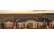 A view of the condo complex and landscape, featuring ponds, hills, and city view at 13456 Via Varra # 428, Broomfield, CO 80020