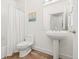 Bathroom featuring tile floors, pedestal sink, and a bathtub with shower at 13456 Via Varra # 428, Broomfield, CO 80020