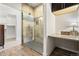 A modern bathroom featuring a tiled shower with a glass door, and granite countertops at 13456 Via Varra # 428, Broomfield, CO 80020