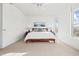 A bright bedroom with white walls, a ceiling fan, and a light brown carpet at 13456 Via Varra # 428, Broomfield, CO 80020