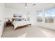 Bright bedroom featuring a ceiling fan, two large windows, and neutral decor at 13456 Via Varra # 428, Broomfield, CO 80020