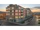 Multi-story condo building featuring stone and siding exterior, with garage and balcony views at 13456 Via Varra # 428, Broomfield, CO 80020