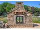 Stone fireplace in the community pool area, offering a cozy outdoor gathering spot at 13456 Via Varra # 428, Broomfield, CO 80020