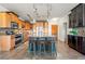Spacious kitchen with large island and bar stool seating, mosaic tile backsplash, and stainless appliances at 13456 Via Varra # 428, Broomfield, CO 80020