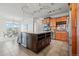 Open kitchen featuring modern track lighting, large island with wine storage, and tile flooring at 13456 Via Varra # 428, Broomfield, CO 80020