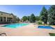 Community pool and hot tub with lounge chairs, outdoor grill, and stone fireplace at 13456 Via Varra # 428, Broomfield, CO 80020