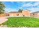 Expansive backyard with lush green grass and mature trees, perfect for outdoor activities at 14595 Robins Dr, Denver, CO 80239