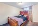 Bedroom featuring a bed with wooden frame and carpet floors at 14595 Robins Dr, Denver, CO 80239
