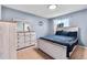 Bedroom with a light blue walls, and a modern bed frame and matching dressers at 14595 Robins Dr, Denver, CO 80239