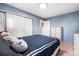 Cozy bedroom with blue walls, closet, and a comfortable bed at 14595 Robins Dr, Denver, CO 80239