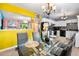 Bright dining room with modern table setting and pass-through to kitchen with stainless appliances at 14595 Robins Dr, Denver, CO 80239