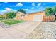 A ranch-style home boasts a driveway and a well-kept lawn with rock landscaping at 14595 Robins Dr, Denver, CO 80239