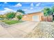 Charming home with a spacious driveway, attached garage, and well-maintained front yard at 14595 Robins Dr, Denver, CO 80239