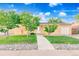 Charming ranch home featuring mature trees, a well-manicured lawn, and inviting curb appeal at 14595 Robins Dr, Denver, CO 80239