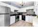 Modern kitchen featuring white cabinetry, stainless steel appliances, and stylish backsplash at 14595 Robins Dr, Denver, CO 80239