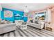 Bright living area featuring sleek laminate flooring, vibrant wall colors, and comfortable seating at 14595 Robins Dr, Denver, CO 80239