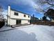 Snowy backyard with deck and partial view of neighboring house at 17984 E Bates Ave, Aurora, CO 80013