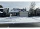 Two-story house with attached garage, snow-covered yard at 17984 E Bates Ave, Aurora, CO 80013