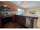 Galley kitchen with stainless steel appliances and wood cabinets at 17984 E Bates Ave, Aurora, CO 80013