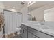 Bathroom featuring gray vanity with white marble countertop, shower with white shower curtain and chrome hardware at 515 Bridger Ave, Fort Lupton, CO 80621