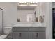 Well-lit bathroom features modern vanity with marble countertop and a decorative mirror at 515 Bridger Ave, Fort Lupton, CO 80621