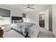 Bright bedroom featuring a ceiling fan, plush carpet, and ensuite bathroom access at 515 Bridger Ave, Fort Lupton, CO 80621