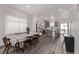 Open-concept dining room featuring sleek laminate floors and modern lighting, perfect for gatherings at 515 Bridger Ave, Fort Lupton, CO 80621