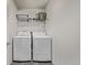 Laundry room with white washer and dryer and storage shelf at 515 Bridger Ave, Fort Lupton, CO 80621