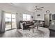 Inviting living room boasts sliding glass doors to patio, neutral decor and lots of natural light at 515 Bridger Ave, Fort Lupton, CO 80621