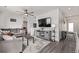 Spacious living room with a comfortable gray sofa, ceiling fan, and stylish décor at 515 Bridger Ave, Fort Lupton, CO 80621