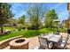 Spacious backyard boasts lush green grass and a stone fire pit with outdoor seating at 17332 E Lake Ln, Aurora, CO 80016