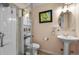 Bright bathroom features a walk-in shower with sleek glass doors and decorative art at 17332 E Lake Ln, Aurora, CO 80016