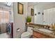 Combined laundry and half bath featuring stylish decor and modern red washer and dryer at 17332 E Lake Ln, Aurora, CO 80016