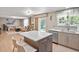 Bright kitchen with island featuring seating, stainless steel appliances and an open floorplan into the living room at 17332 E Lake Ln, Aurora, CO 80016