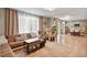 Open-concept living space that blends the kitchen into a well-furnished living room with a window and soft curtains at 17332 E Lake Ln, Aurora, CO 80016