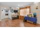 Spacious living room with wood floors, large window, TV, and closet space at 17332 E Lake Ln, Aurora, CO 80016