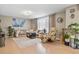 Cozy living room with comfortable seating, light-filled window with sheer curtains, and modern decor at 17332 E Lake Ln, Aurora, CO 80016